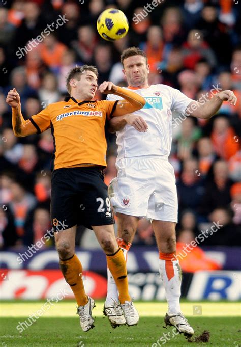 Blackpool's Ian Evatt, right, competes for the ball with  .